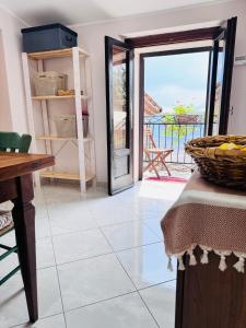 a room with a door open to a patio with a table at Villa Artemide - Ospitalità nel Borgo in Marsico Vetere