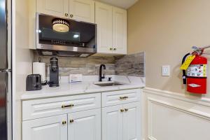 a kitchen with a sink and a microwave at Nurse-Ready Studio Retreat! 2 Mi to Dtwn Holyoke in Holyoke