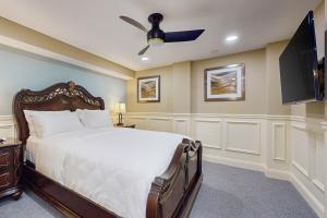 a bedroom with a bed and a flat screen tv at Nurse-Ready Studio Retreat! 2 Mi to Dtwn Holyoke in Holyoke +9 photos