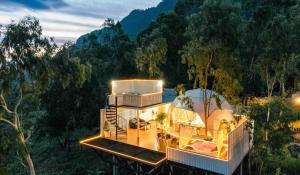 a house in the middle of a forest with a tent at Paradiso Khaokho By N in Ban Huai Phai