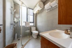a bathroom with a sink and a toilet and a shower at 闲山民宿 CosyValley Inn in Hangzhou +26 photos