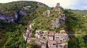 an old village on the side of a mountain at Longo maï in Vallon-Pont-dʼArc