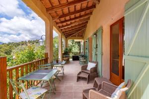 a porch with tables and chairs on a balcony at Gite Mare e Monti in Vico