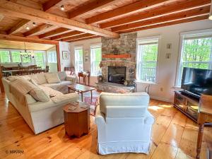 a living room with a couch and a fireplace at Shady Lane Retreat in Waitsfield