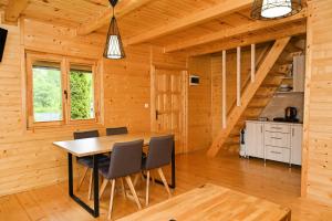 a dining room with a table and chairs in a cabin at Cottage Sunshine in Jajce
