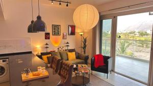 a living room with a couch and a table at Century Stay by Bait Zain in As Sīfah