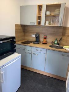 a kitchen with a sink and a microwave at Urlaub in Horn in Horn +14 photos