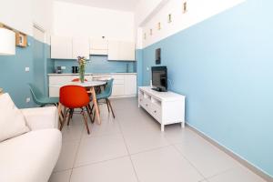 a kitchen and living room with a couch and a table at Maréa apartments - Sul mare 2 in Alba Adriatica