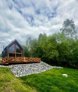 a cabin with a bridge over a pile of rocks at Gawra Pogórze in Jawornik Polski +19 photos