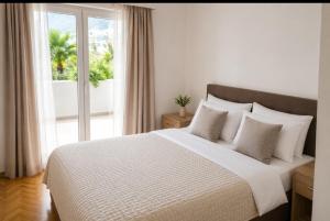a bedroom with a large white bed with a window at Apartman Taraca Villa Knezevic in Herceg-Novi +32 photos