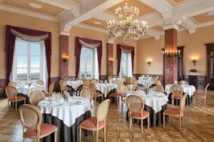 a dining room with tables and chairs and a chandelier at Sina Brufani in Perugia