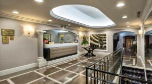 a hallway with a lobby with a bar and stairs at Sina Maria Luigia in Parma