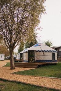 a blue and white yurt sitting next to a tree at Yurt Mongolia - Camp La Belle Vie in Berdorf