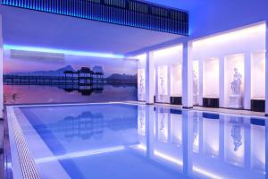 a large swimming pool in a house with a pool at Hotel Sina Astor in Viareggio