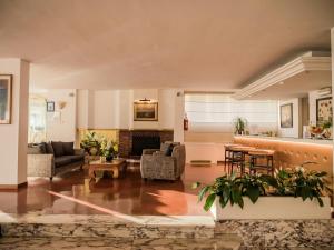 a living room filled with furniture and a fireplace at Hotel Sina Astor in Viareggio