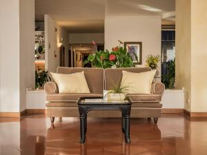 a living room with a couch and a coffee table at Hotel Sina Astor in Viareggio