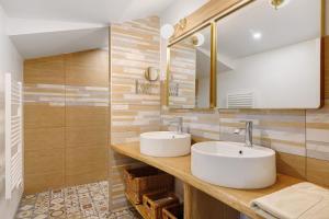 a bathroom with two sinks and a mirror at Gîte La Ferme Du Mesnil in Sevremont +27 photos