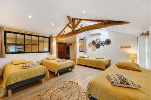 a room with three beds in a room at Gîte La Ferme Du Mesnil in Sevremont