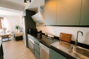 a kitchen with a sink and a counter top at Casita Capricho in Zuheros