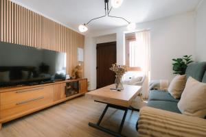 a living room with a large flat screen tv at Casita Capricho in Zuheros