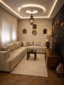 a living room with a couch and a table at Azra Luxe villa famille uniquement Family only in Saïdia