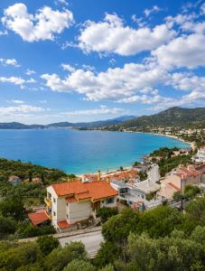 a view of a town and a body of water at Nickolas Sea View Apartment in Paleo Tsifliki