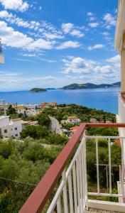 a view of the water from the balcony of a house at Nickolas Sea View Apartment in Paleo Tsifliki