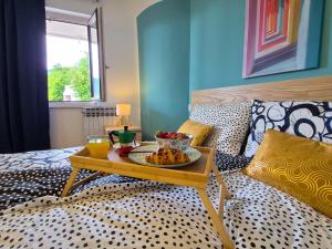 a tray of fruit on a table on a bed at Casa Morlacca in Matulji