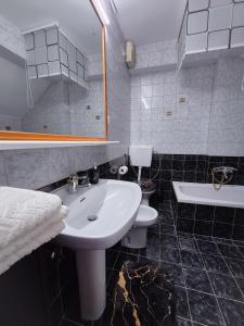 a bathroom with a sink and a toilet and a mirror at Casa Morlacca in Matulji +28 photos