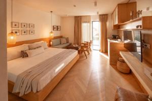 a bedroom with a large bed and a kitchen at Mamei Boutique Villa in Dobrota