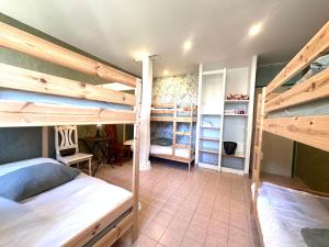 a room with two bunk beds and a desk at La Bastide en Margeride in Châteauneuf-de-Randon
