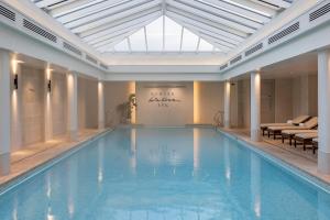 a large swimming pool with a skylight in a building at Old Course Hotel St Andrews in St. Andrews