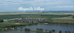 an aerial view of a river with a village at Magnolia Residence Premium in Găgeni