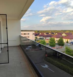 a balcony with a view of a parking lot at Magnolia Residence Premium in Găgeni