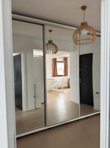 a sliding glass door in a room with a living room at Magnolia Residence Premium in Găgeni