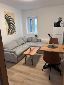 a living room with a couch and a table at Soti Apartments in Kupari