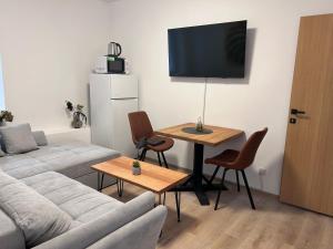 a living room with a couch and a table at Soti Apartments in Kupari