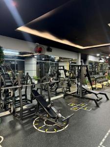 a gym with several treadmills and machines at Hiền Apartment in Thôn Văn Dương