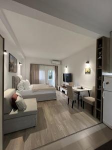 a bedroom with a bed and a desk and a table at Apartman Vera in Sušćepan