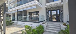 a rendering of a house with glass doors at Marine Apartment in Nea Peramos