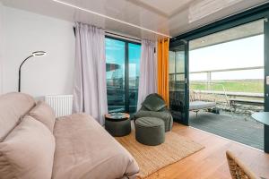a living room with a couch and a chair at Sea Lodge in Vieregge