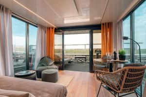 a bedroom with a bed and a table and chairs at Sea Lodge in Vieregge