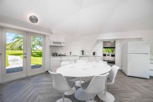 a kitchen and dining room with a white table and chairs at Sumner Lake Tiny House 1B in Clermont