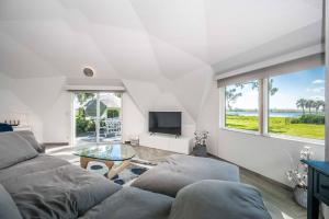 a living room with a couch and a tv at Sumner Lake Tiny House 1B in Clermont