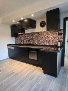 a kitchen with black cabinets and a counter top at Ferienwohnung Monteurzimmer Mariens1 in Eppelborn