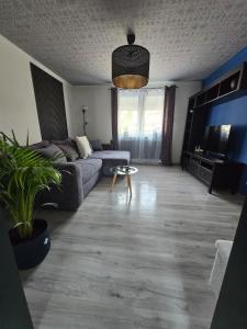 a living room with a couch and a tv at Ferienwohnung Monteurzimmer Mariens1 in Eppelborn +2 photos