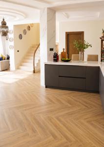 a kitchen with wooden flooring and a staircase at Azra Luxe villa famille uniquement Family only in Saïdia