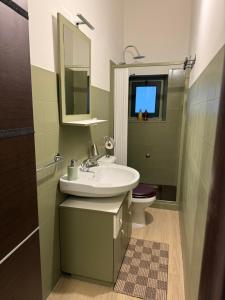 a bathroom with a sink and a toilet at Casa Bucalo 2, Taormina in Taormina +25 photos