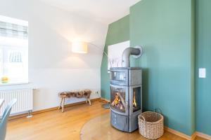 a fireplace in a living room with a table at Schloss am Meer App 5 in Ahlbeck