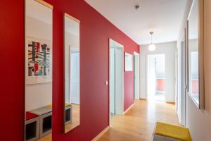 a hallway with red walls and a red wall at Schloss am Meer App 5 in Ahlbeck +9 photos